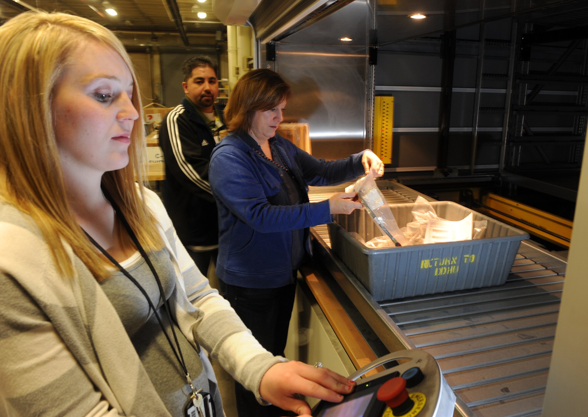 Distribution Logistics Agency Aviation Material Support Technicians Jennifer Loffredo (left), Janet Santos and Tommy Espinoza prepare to move A-10 aircraft parts at Hill Air Force Base. The parts are being moved from Hangar 1 to Building 225 to decrease the time mechanics spend waiting on parts to be delivered. (U.S Air Force photo by Alex Lloyd)