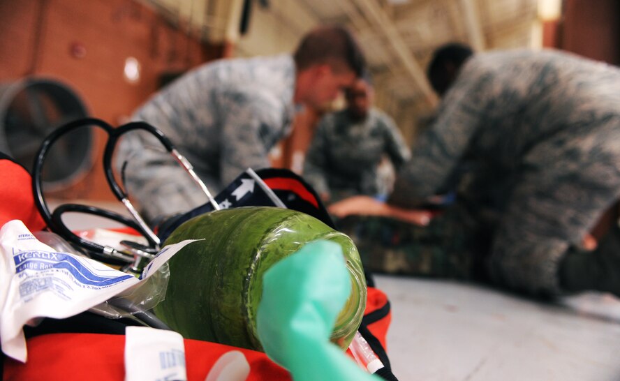 MOODY AIR FORCE BASE, Ga.-- A bag of medical supplies sits as students of the first responder’s course treat a trauma victim April 13. Students were put through three scenarios to include bleed control and shock treatment, delivery of a baby and treatment of a trauma victim during the practical exam of the course. (U.S. Air Force photo/Airman 1st Class Benjamin Wiseman)(RELEASED)
