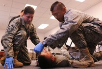 MOODY AIR FORCE BASE, Ga.--Master Sgts. Samuel Louie and Jason Castro, 820th Combat Operations Squadron, treat Airman 1st Class Jarrett Rowe, 824th Base Defense Squadron member and practical exam volunteer, during the bleeding control and shock treatment portion of the first responders course April 13. The first responder’s course gives personnel the ability to assess and treat accident victims until higher qualified medical providers arrive on scene. (U.S. Air Force photo/Airman 1st Class Benjamin Wiseman)(RELEASED)