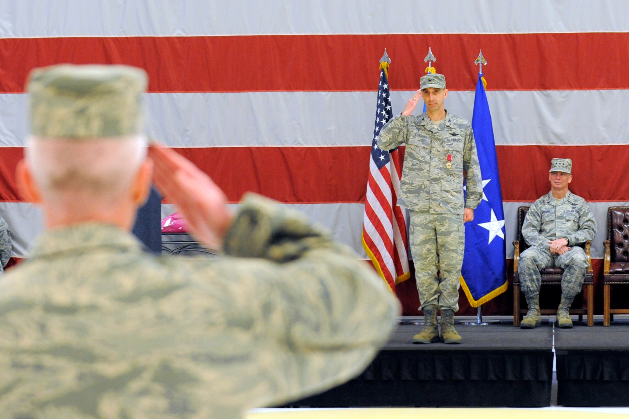 Col. Scott Long, 388th Fighter Wing commander, salutes the men and women of the 388th Fighter Wing at the change of command ceremony April 7 as Lt. Gen. Glenn Spears, 12th Air Force commander, awaits the completion. (U.S. Air Force photo by Todd Cromar)