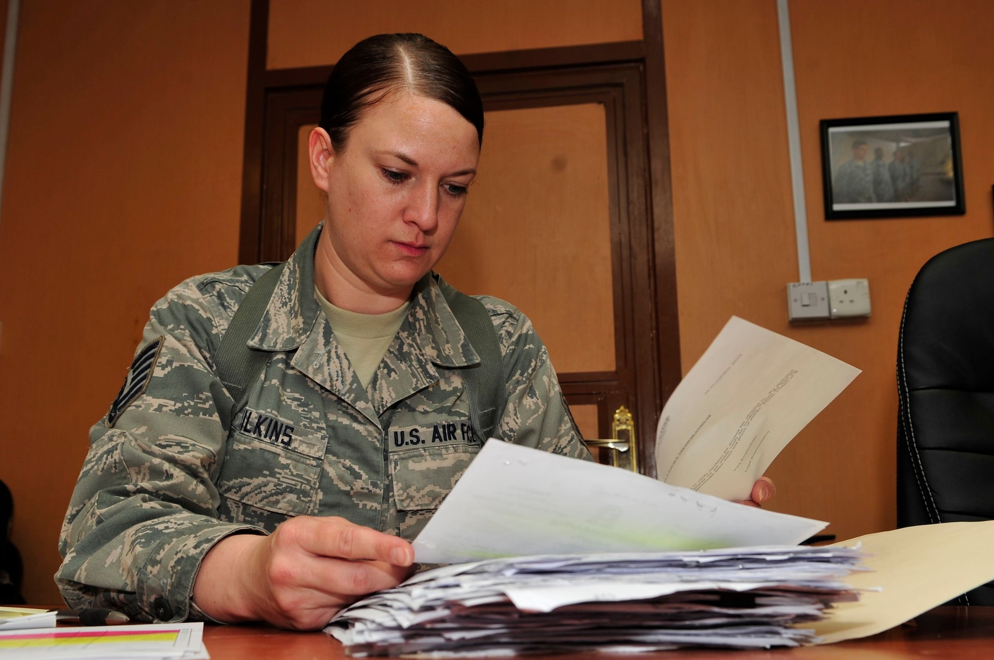 U.S. Air Force Tech. Sgt. Diana Wilkins, Law and Order Task Force paralegal, deployed from Buckley Air Force Base, Colo., and native of Colorado Springs, Colo., has the tedious task of reviewing thousands of paper files and millions of megabytes of electronic data to piece together a case at Joint Security Station Shield, Baghdad, Iraq, April 7, 2011. Her work builds a case file that she turns over to the Iraqi justice system to try a detainee in Iraqi custody. (U.S. Air Force photo by Senior Master Sgt. Larry A. Schneck/Released)