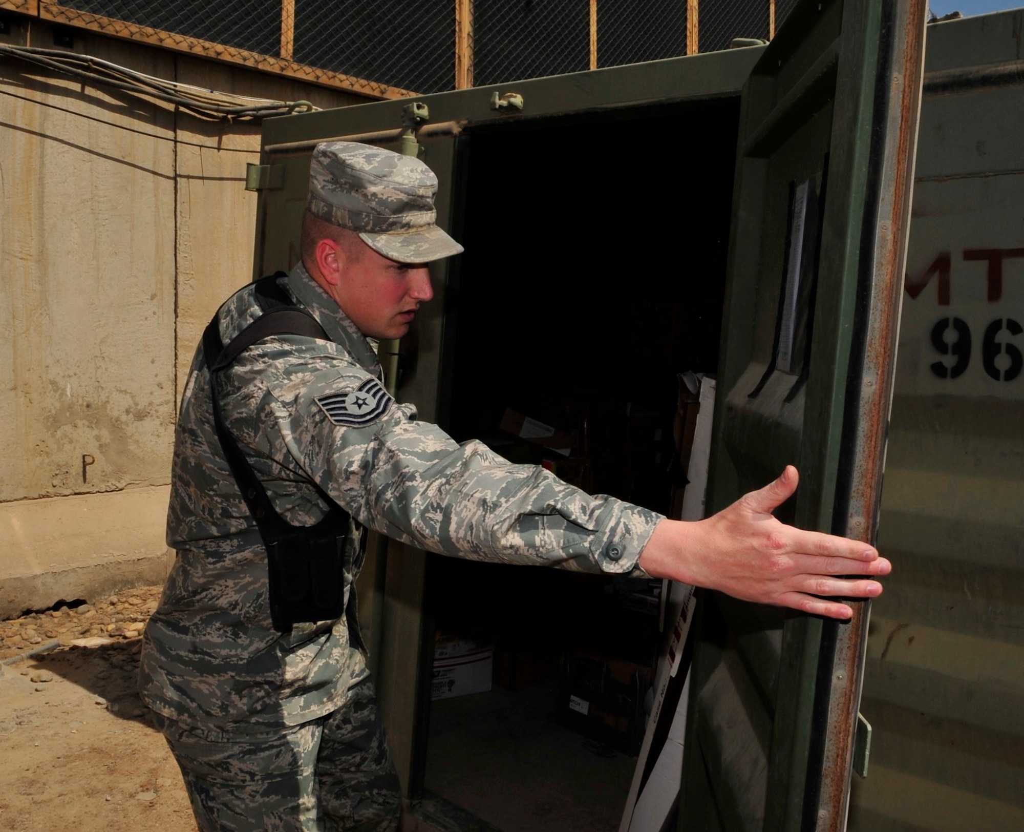U.S. Air Force Tech. Sgt. Aaron Holmes, deployed from Grand Forks Air Force Base, N.D., and native of Cabot, Ark., opens the door of an evidence locker on Joint Security Station Shield, Iraq, April 7, 2011. Sergeant Holmes is a 17-year veteran and a paralegal assigned to the Law and Order Task Force. LAOTF Airmen gather and review evidence and documents on Iraqi detainees then turn over the cases to the Iraqi justice system. (U.S. Air Force photo by Senior Master Sgt. Larry A. Schneck)