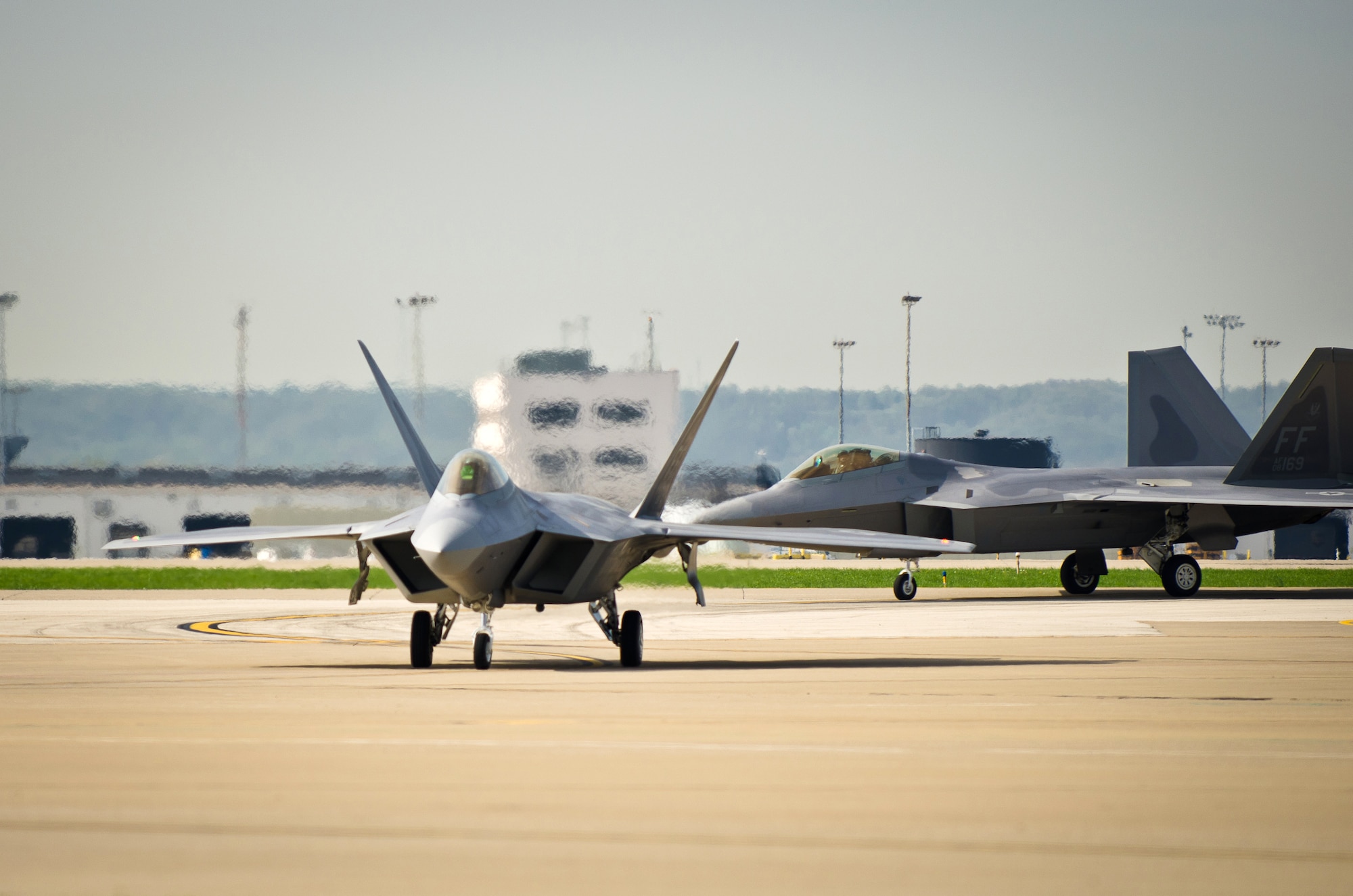 Two U.S. Air Force F-22 Raptors arrive at the Kentucky Air National Guard Base in Louisville, Ky., on April 14, 2011, in preparation for the Thunder Over Louisville air show. The Raptors will be one of show?s marquee events when Thunder takes place over the Ohio River on April 16. The annual event has become one of the nation?s largest air shows, with nearly 60 aircraft slated to perform this year for a crowd that?s expected to top 750,000. (U.S. Air Force photo by Maj. Dale Greer)