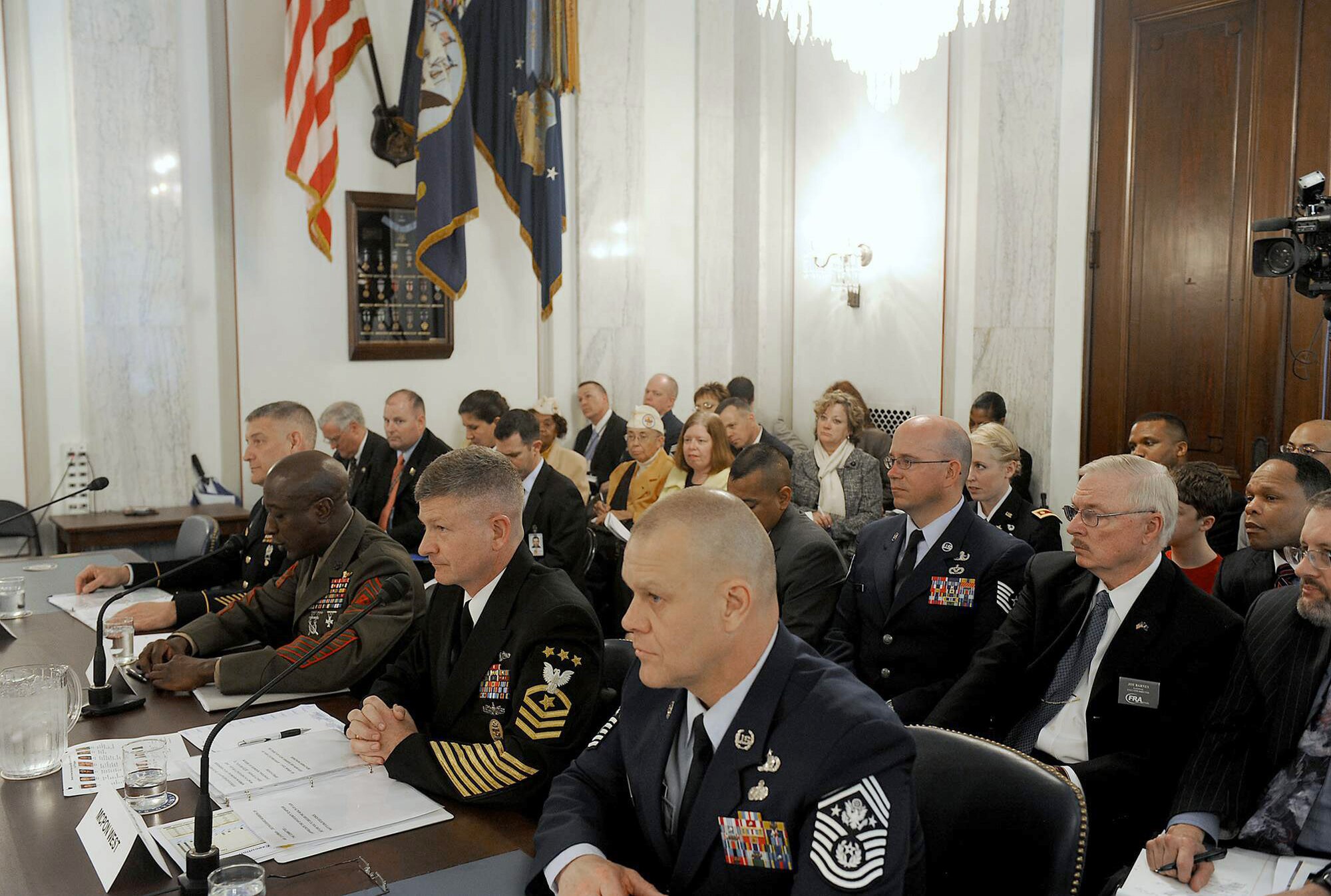 Chief Master Sgt. of the Air Force James A. Roy (right) shares the witness stand while Sgt. Maj. of the Marine Corps Carlton Kent delivers his opening statement during a Senate Armed Services subcommittee hearing on military personnel issues April 13, 2011, in Washington. Also testifying were Sgt. Maj. of the Army Raymond Chandler III and Master Chief Petty Officer of the Navy Rick West. (U.S. Air Force photo/Scott M. Ash)