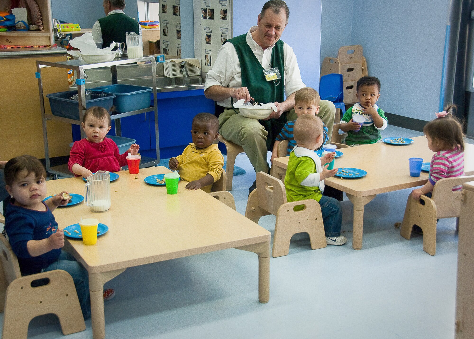 Bob Huber, the pre-toddler room lead at the Yume Child Development Center at Yokota Air Base, Japan, feeds an afternoon snack to children April 12, 2011. Caregivers at Yokota Air Base CDCs work together to continue normal routines with the children by carrying on everyday activities in the aftermath of the earthquake and tsunami. (U.S. Air Force photo/Airman 1st Class Lynsie Nichols)