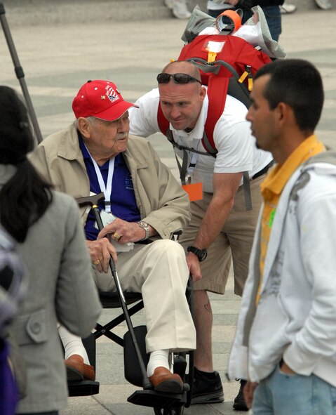 DYESS AIR FORCE BASE, Texas - An Abilene, Texas volunteer talks with one of more than 200 World War II veterans while visiting the World War II Memorial in Washington D.C. April 12 as part of a West Texas Honor Flight Network event. The Honor Flight Network is a non-profit organization created to honor America’s veterans for their sacrifices by transporting these heroes to Washington D.C. to visit and reflect at their memorials at no cost to themselves. Honor Flight trips are made possible through donations; discounts by charter bus companies, airlines, hotels and more; and through volunteers, of which more than 100 were present during this West Texas Honor Flight. (Air Force photo/Tech. Sgt. Robert Wollenberg)