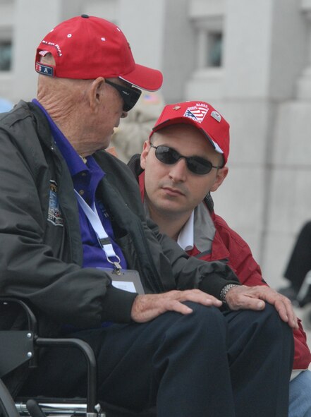 DYESS AIR FORCE BASE, Texas - A Dyess Air Force Base Airman talks with one of more than 200 World War II veterans while visiting the World War II Memorial in Washington D.C. April 12 as part of a West Texas Honor Flight Network event. The Honor Flight Network is a non-profit organization created to honor America’s veterans for their sacrifices by transporting these heroes to Washington D.C. to visit and reflect at their memorials at no cost to themselves. Honor Flight trips are made possible through donations; discounts by charter bus companies, airlines, hotels and more; and through volunteers, of which more than 100 were present during this West Texas Honor Flight. (Air Force photo/Tech. Sgt. Robert Wollenberg)