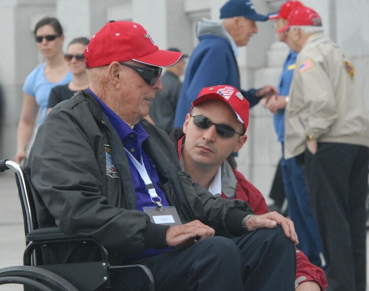 DYESS AIR FORCE BASE, Texas - A Dyess Air Force Base Airman talks with one of more than 200 World War II veterans while visiting the World War II Memorial in Washington D.C. April 12 as part of a West Texas Honor Flight Network event. The Honor Flight Network is a non-profit organization created to honor America’s veterans for their sacrifices by transporting these heroes to Washington D.C. to visit and reflect at their memorials at no cost to themselves. Honor Flight trips are made possible through donations; discounts by charter bus companies, airlines, hotels and more; and through volunteers, of which more than 100 were present during this West Texas Honor Flight. (Air Force photo/Tech. Sgt. Robert Wollenberg)