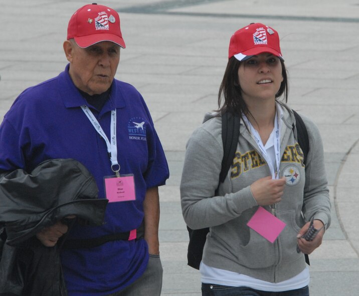 DYESS AIR FORCE BASE, Texas - A Dyess Airman walks with one of more than 200 World War II veterans while visiting the World War II Memorial in Washington D.C. April 12 as part of a West Texas Honor Flight Network event. The Honor Flight Network is a non-profit organization created to honor America’s veterans for their sacrifices by transporting these heroes to Washington D.C. to visit and reflect at their memorials at no cost to themselves. Honor Flight trips are made possible through donations; discounts by charter bus companies, airlines, hotels and more; and through volunteers, of which more than 100 were present during this West Texas Honor Flight. (Air Force photo/Tech. Sgt. Robert Wollenberg)