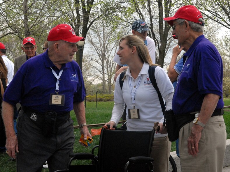DYESS AIR FORCE BASE, Texas - Senior Airman Jamie Smith, 7th Operations Support Squadron, talks with World War II veterans while visiting the World War II Memorial in Washington D.C. April 12 as part of a West Texas Honor Flight Network event. The Honor Flight Network is a non-profit organization created to honor America’s veterans for their sacrifices by transporting these heroes to Washington D.C. to visit and reflect at their memorials at no cost to themselves. Honor Flight trips are made possible through donations; discounts by charter bus companies, airlines, hotels and more; and through volunteers, of which more than 100 were present during this West Texas Honor Flight. (Air Force photo/Tech. Sgt. Robert Wollenberg)