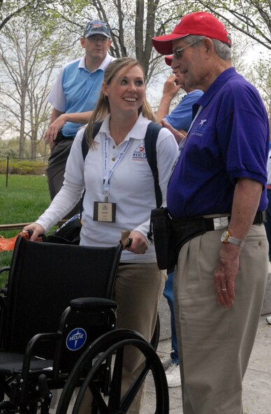 DYESS AIR FORCE BASE, Texas - Senior Airman Jamie Smith, 7th Operations Support Squadron, talks with one of more than 200 World War II veterans while visiting the World War II Memorial in Washington D.C. April 12 as part of a West Texas Honor Flight Network event. The Honor Flight Network is a non-profit organization created to honor America’s veterans for their sacrifices by transporting these heroes to Washington D.C. to visit and reflect at their memorials at no cost to themselves. Honor Flight trips are made possible through donations; discounts by charter bus companies, airlines, hotels and more; and through volunteers, of which more than 100 were present during this West Texas Honor Flight. (Air Force photo/Tech. Sgt. Robert Wollenberg)