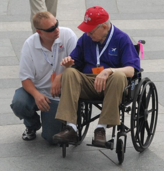 DYESS AIR FORCE BASE, Texas - A Dyess Airman talks with one of more than 200 World War II veterans while visiting the World War II Memorial in Washington D.C. April 12 as part of a West Texas Honor Flight Network event. The Honor Flight Network is a non-profit organization created to honor America’s veterans for their sacrifices by transporting these heroes to Washington D.C. to visit and reflect at their memorials at no cost to themselves. Honor Flight trips are made possible through donations; discounts by charter bus companies, airlines, hotels and more; and through volunteers, of which more than 100 were present during this West Texas Honor Flight. (Air Force photo/Tech. Sgt. Robert Wollenberg)