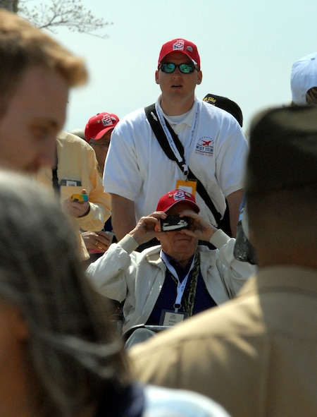 DYESS AIR FORCE BASE, Texas - A Dyess Airman helps one of more than 200 World War II veterans around the World War II Memorial in Washington D.C. April 12 as part of a West Texas Honor Flight Network event. The Honor Flight Network is a non-profit organization created to honor America’s veterans for their sacrifices by transporting these heroes to Washington D.C. to visit and reflect at their memorials at no cost to themselves. Honor Flight trips are made possible through donations; discounts by charter bus companies, airlines, hotels and more; and through volunteers, of which more than 100 were present during this West Texas Honor Flight. (Air Force photo/Tech. Sgt. Robert Wollenberg)