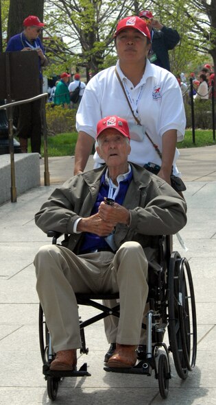 DYESS AIR FORCE BASE, Texas - A Dyess Airman helps one of more than 200 World War II veterans around the World War II Memorial in Washington D.C. April 12 as part of a West Texas Honor Flight Network event. The Honor Flight Network is a non-profit organization created to honor America’s veterans for their sacrifices by transporting these heroes to Washington D.C. to visit and reflect at their memorials at no cost to themselves. Honor Flight trips are made possible through donations; discounts by charter bus companies, airlines, hotels and more; and through volunteers, of which more than 100 were present during this West Texas Honor Flight. (Air Force photo/Tech. Sgt. Robert Wollenberg)