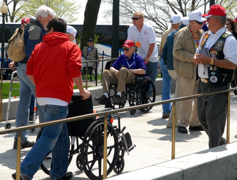 DYESS AIR FORCE BASE, Texas - A Dyess Airman helps one of more than 200 World War II veterans around the World War II Memorial in Washington D.C. April 12 as part of a West Texas Honor Flight Network event. The Honor Flight Network is a non-profit organization created to honor America’s veterans for their sacrifices by transporting these heroes to Washington D.C. to visit and reflect at their memorials at no cost to themselves. Honor Flight trips are made possible through donations; discounts by charter bus companies, airlines, hotels and more; and through volunteers, of which more than 100 were present during this West Texas Honor Flight. (Air Force photo/Tech. Sgt. Robert Wollenberg)