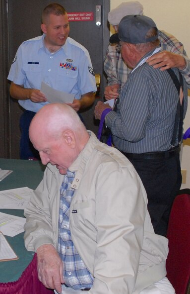 DYESS AIR FORCE BASE, Texas - Senior Airman Adam Tutt, 77th Weapons Squadron, helps World War II veterans inprocess for their “trip of a lifetime” April 11 at the MGM Elegante hotel as part of a West Texas Honor Flight Network event to Washington D.C. The Honor Flight Network is a non-profit organization created to honor America’s veterans for their sacrifices by transporting these heroes to Washington D.C. to visit and reflect at their memorials at no cost to themselves. Honor Flight trips are made possible through donations; discounts by charter bus companies, airlines, hotels and more; and through volunteers, of which more than 100 were present during this West Texas Honor Flight. (Air Force photo/Tech. Sgt. Robert Wollenberg)