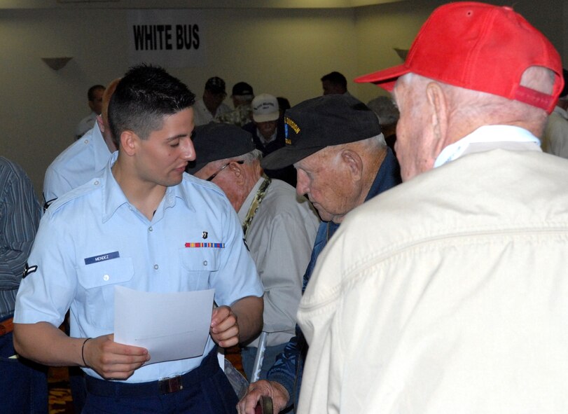 DYESS AIR FORCE BASE, Texas - Airman Joshua Mendez, 7th Medical Operations Squadron, helps World War II veterans inprocess for their “trip of a lifetime” April 11 at the MGM Elegante hotel as part of a West Texas Honor Flight Network event to Washington D.C. The Honor Flight Network is a non-profit organization created to honor America’s veterans for their sacrifices by transporting these heroes to Washington D.C. to visit and reflect at their memorials at no cost to themselves. Honor Flight trips are made possible through donations; discounts by charter bus companies, airlines, hotels and more; and through volunteers, of which more than 100 were present during this West Texas Honor Flight. (Air Force photo/Tech. Sgt. Robert Wollenberg) 

