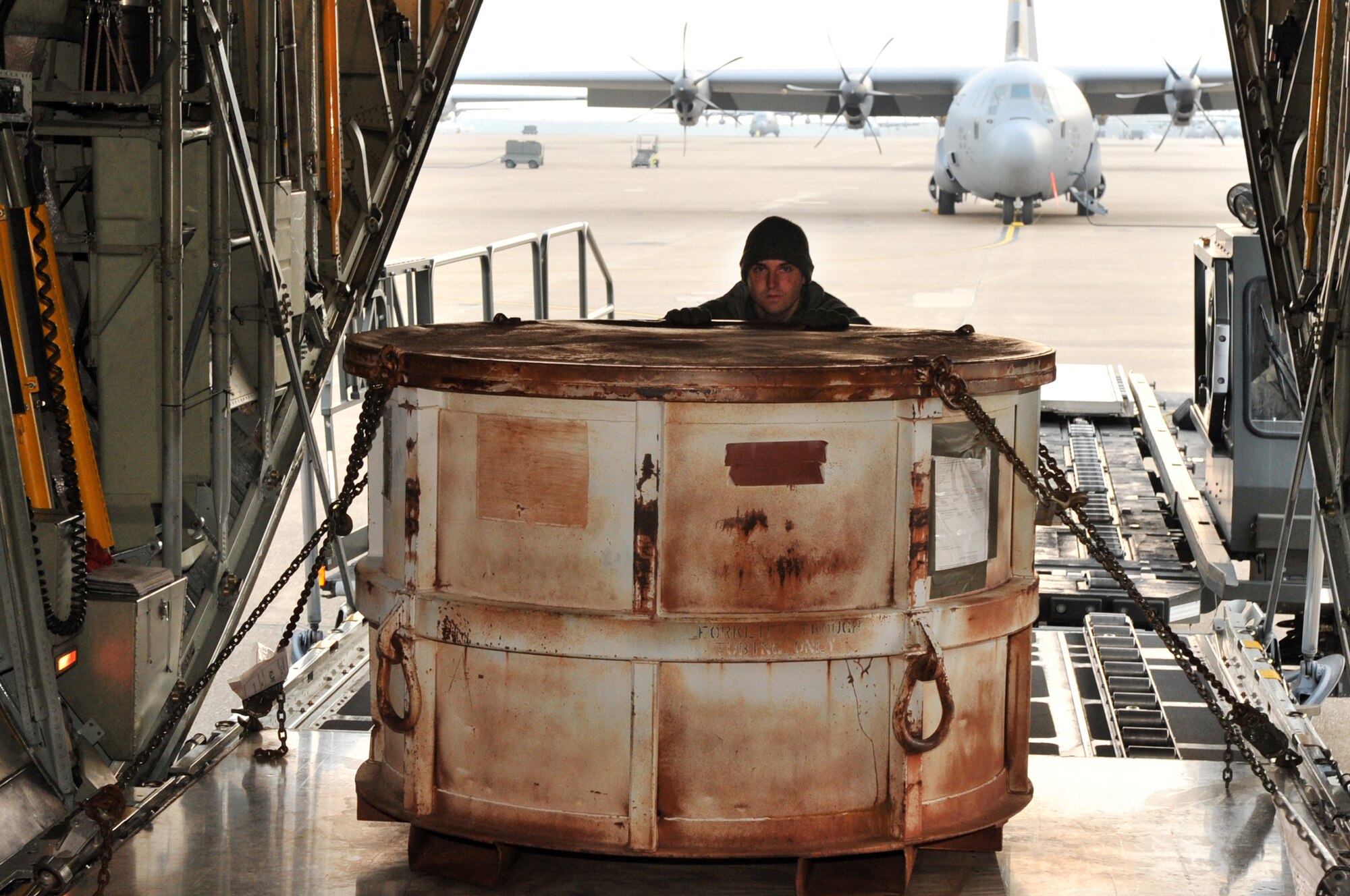 Senior Airman Keith White, a 19th Logistics Readiness Squadron aircraft services element member, loads cargo onto a C-130 March 25, 2011, at Little Rock Air Force Base, Ark. (U.S. Air Force photo by Airman 1st Class Rusty Frank)