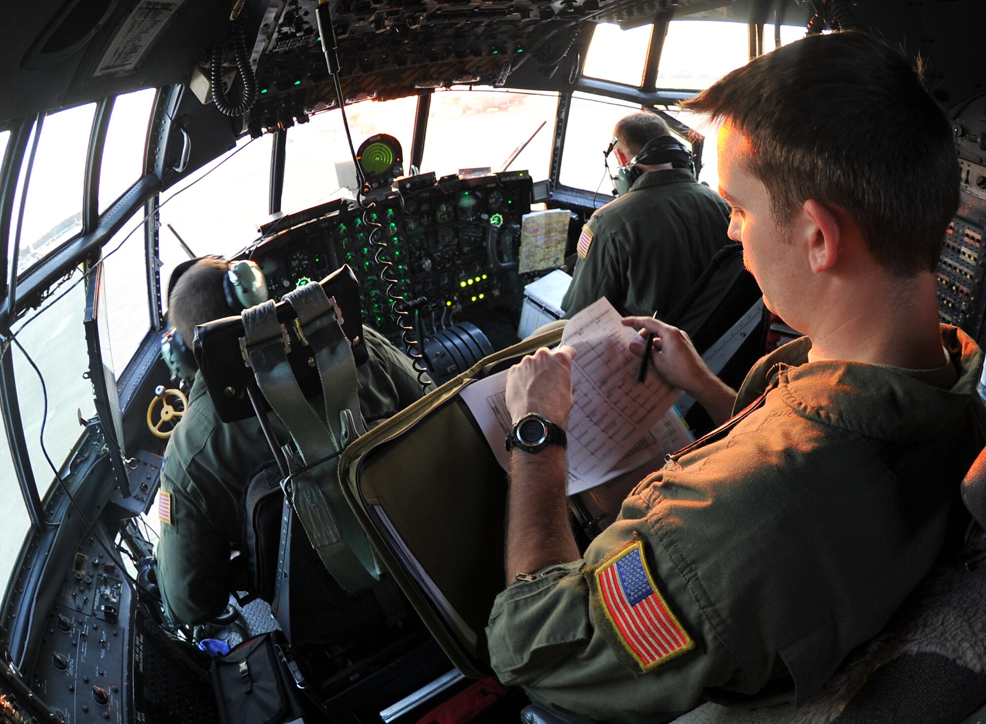 Staff Sgt. Chris Bickley, a 50th Airlift Squadron flight engineer, performs a pre-flight check inside the flight deck of a C-130 March 24, 2011, on the flightline at Little Rock Air Force Base, Ark. Sergeant Bickley also looks around the C-130 with the aircraft’s crew chief to assist in pre-flight inspections.  (U.S. Air Force photo by Staff Sgt. Chris Willis)