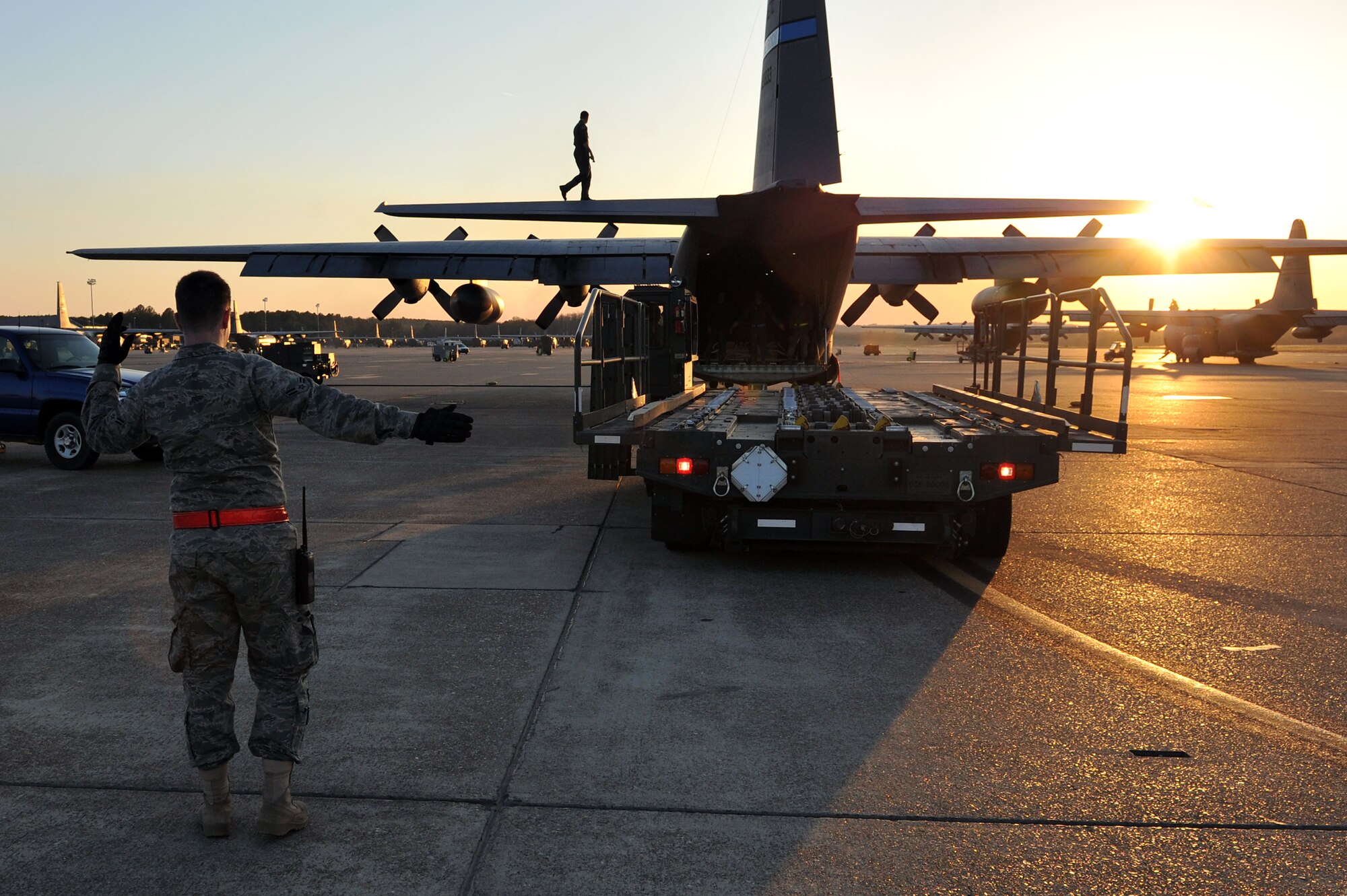 Loadmasters from the 189th Airlift Wing bring cargo into a C-130 Hercules March 24, 2011, at Little Rock Air Force Base, Ark.  The 189th AW is one of the three wings at Little Rock producing the largest C-130 fleet in the world.  (U.S. Air Force photo by Staff Sgt. Chris Willis)