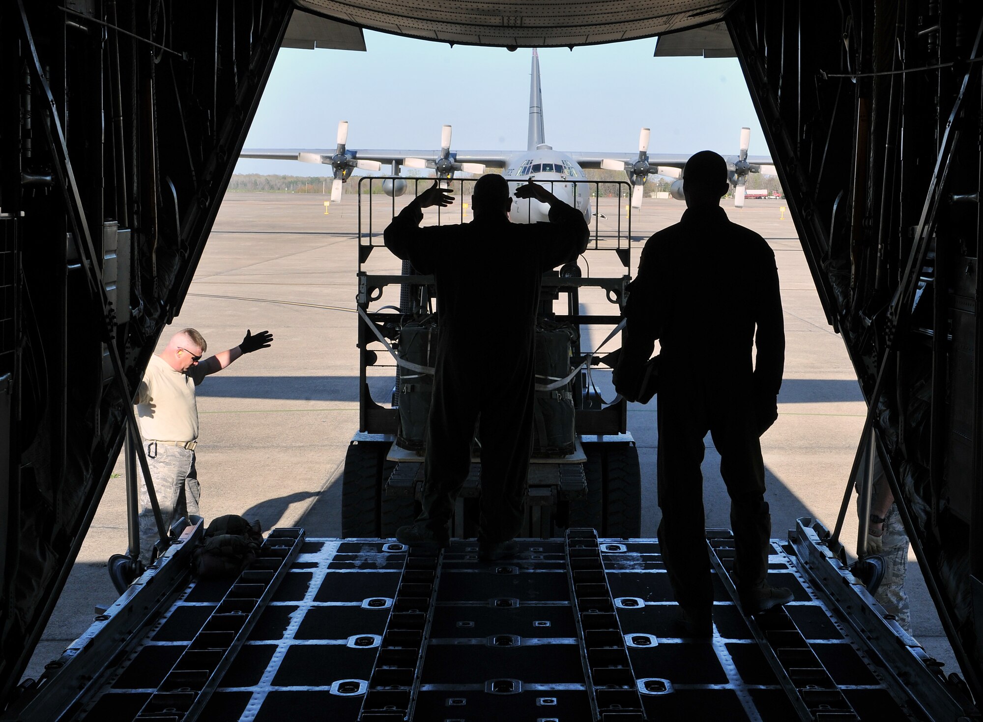 Loadmasters from the 189th Airlift Wing bring cargo into a C-130 Hercules March 24, 2011, at Little Rock Air Force Base, Ark.  The 189th AW is one of the three wings at Little Rock producing the largest C-130 fleet in the world.  (U.S. Air Force photo by Staff Sgt. Chris Willis)