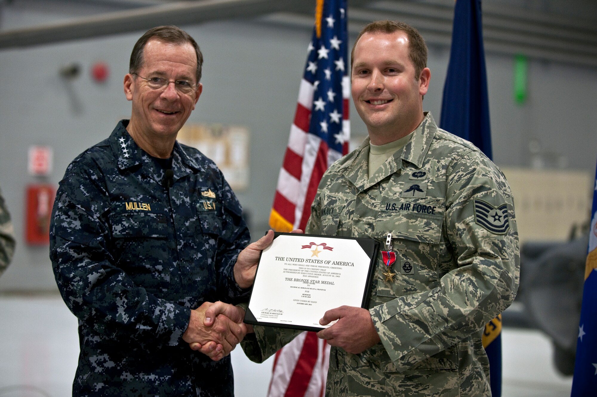 NELLIS AIR FORCE BASE, Nev. -- Chairman of the Joint Chiefs of Staff Navy Adm. Mike Mullen awards a Bronze Star with valor to Tech. Sgt. Ryan Manjuck, 58th Rescue Squadron pararescueman, April 13. Sergeant Manjuck is one of three pararescuemen awarded the Bronze Star for their heroic actions while rescuing wounded American Soldiers last year in Afghanistan. (U.S. Air Force photo by Tech. Sgt. Michael Holzworth)
