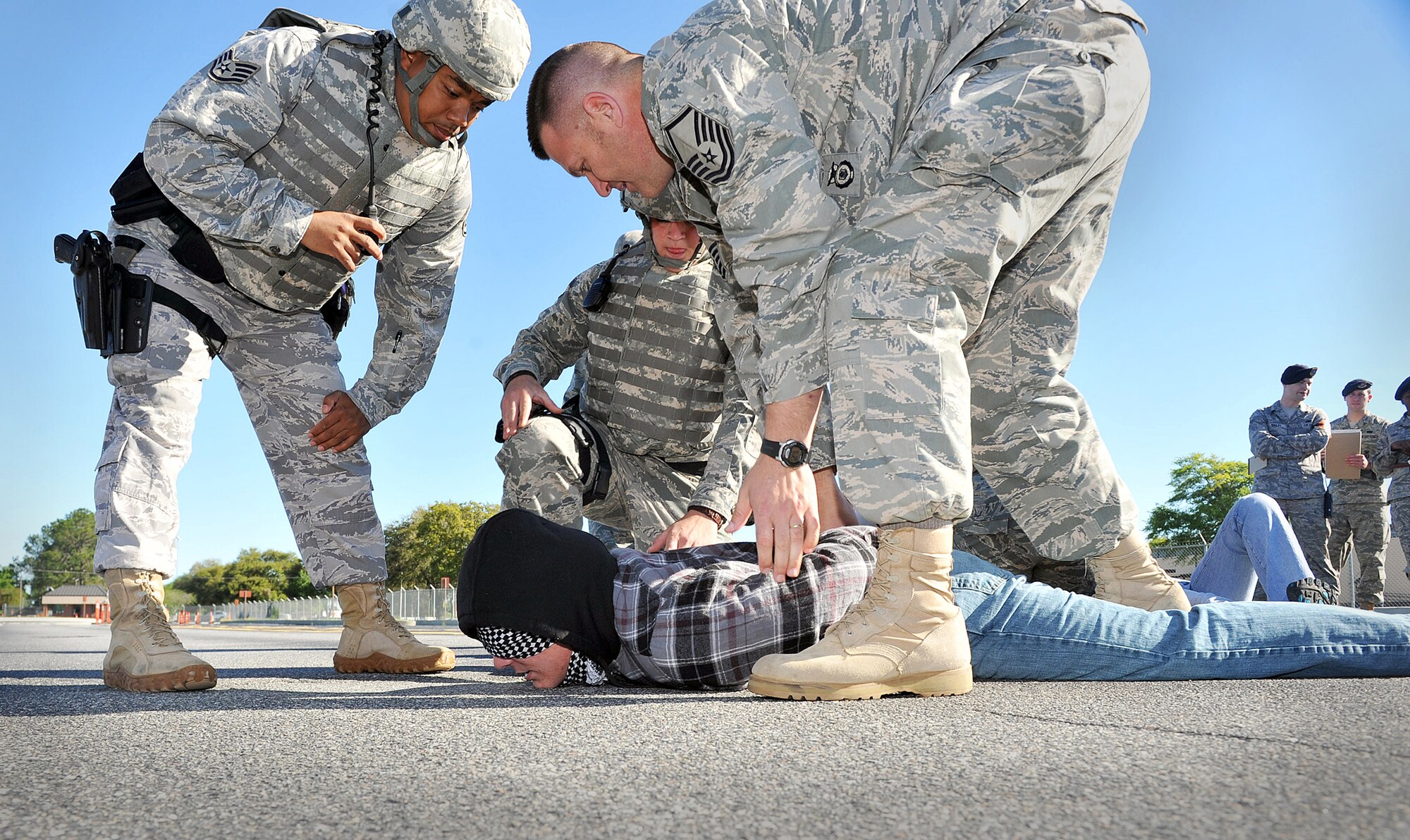 A "protester" is detained by 78th Security Forces Squadron members during an exercise last week. Volunteers simulated a protest just outside the Martin Luther King gate to test the response of base personnel. U. S. Air Force photo by Tommie Horton