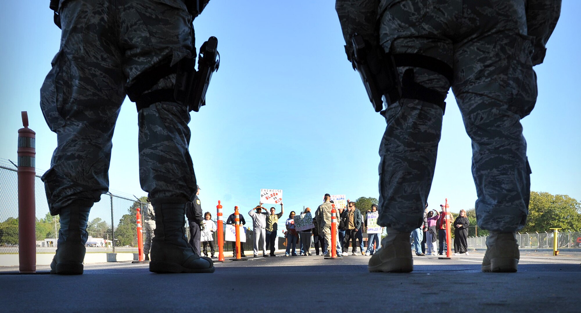 Volunteers simulated a protest just outside the Martin Luther King gate during an exercise last week to test the response of base personnel. U. S. Air Force photo by Tommie Horton
