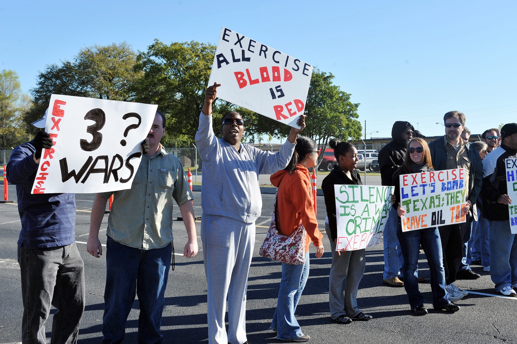 Volunteers simulated a protest just outside the Martin Luther King gate during an exercise last week to test the response of base personnel. U. S. Air Force photo by Tommie Horton