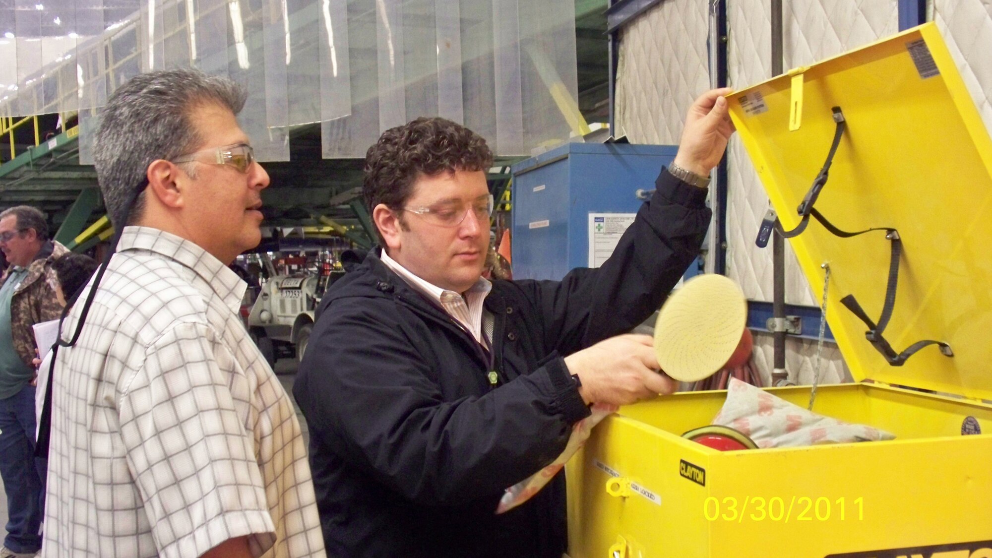 Joshua Smith, Delta Technical Operations Center (right), explains tools the organization uses to Maurice Zammit, WR-ALC Workplace Safety and Health Team member. The team visited Delta to learn about its best practices. U. S. Air Force photo by Faye Banks-Anderson