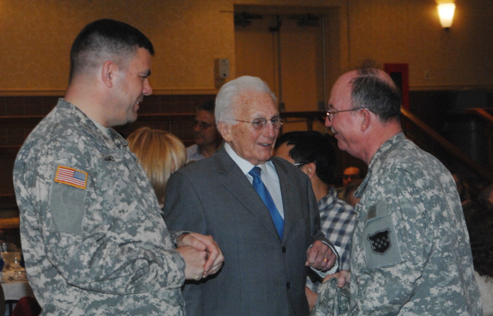 Col. Patrick Slowey, Army Support Activity-Dix commander, at left, and Maj. Gen. William D. R. Waff, 99th Regional Support Command commanding general, flank Steve Whitmore and congratulate him on a combined 68 years of military and civil service upon retiring at Morgan’s April 5. (U.S. Army photo by David Moore/Released)