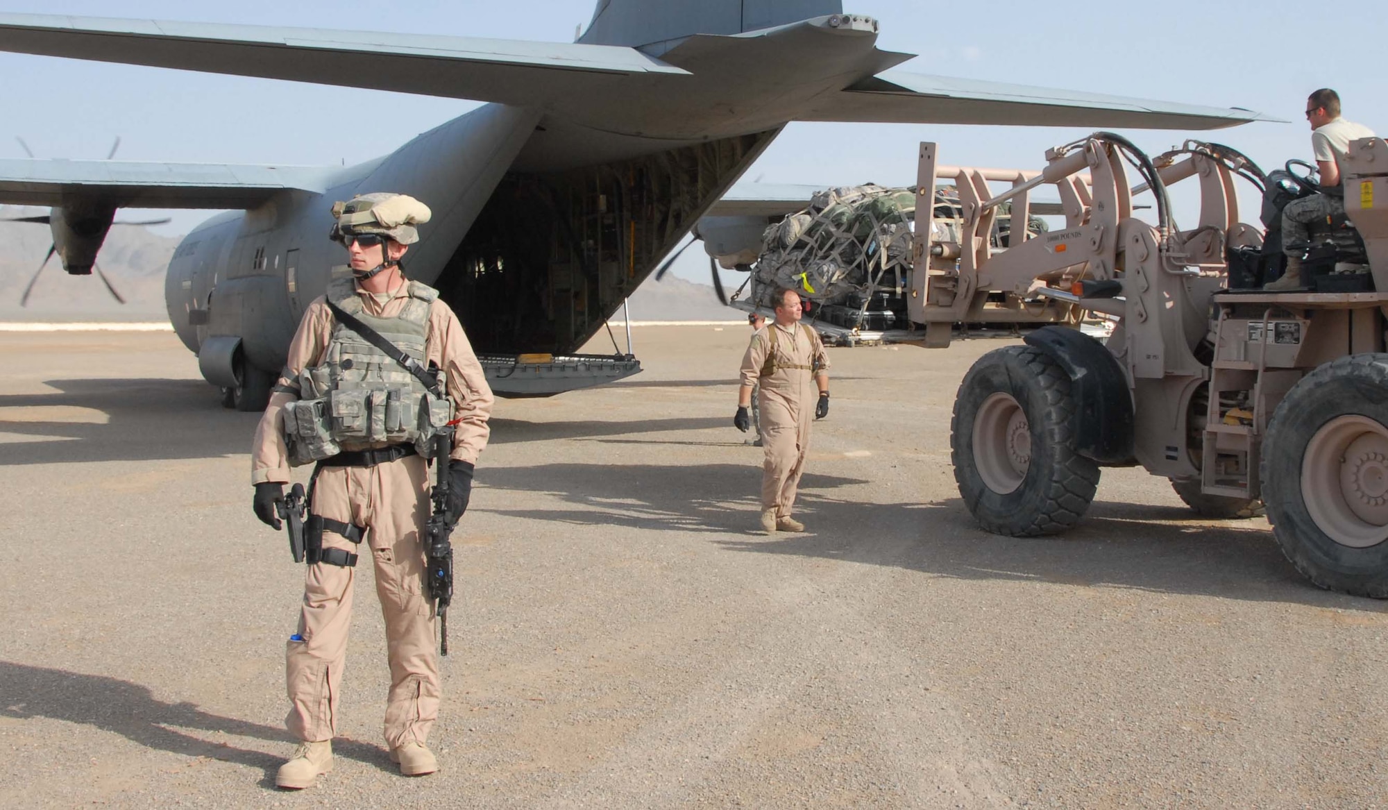 Staff Sgt. Mark King guards the back of a C-130, April 10, 2011, in Afghanistan. The Fly Away Security Team is the first to step off the plane on an unsecured runway, which may have no fence or security. The Airmen will sweep the area for explosives, then watch for suspicious people who try to approach or board the aircraft. Sergeant King is a FAST member assigned to the 451st Expeditionary Security Forces Squadron. (U.S. Air Force photo/Tech. Sgt. Emily F. Alley/Released)