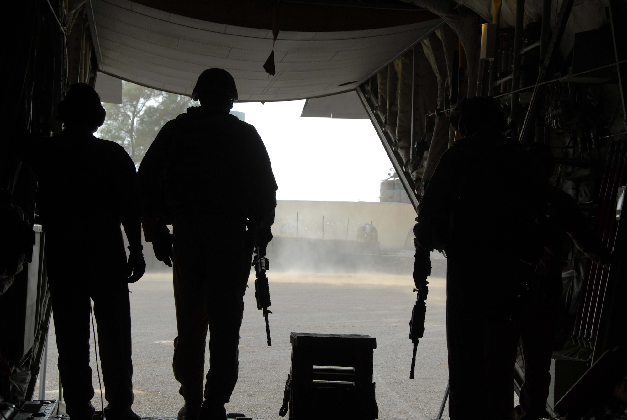 A Fly Away Security Team prepares to step out the back of a C-130, April 10, 2011, in Afghanistan. The FAST Airmen are the first to step off the plane on an unsecured runway, which may have no fence or security. The Airmen will sweep the area for explosives, then watch for suspicious people who try to approach or board the aircraft. FAST Airmen are assigned to the 451st Expeditionary Security Forces Squadron. (U.S. Air Force photo/Tech. Sgt. Emily F. Alley/Released)