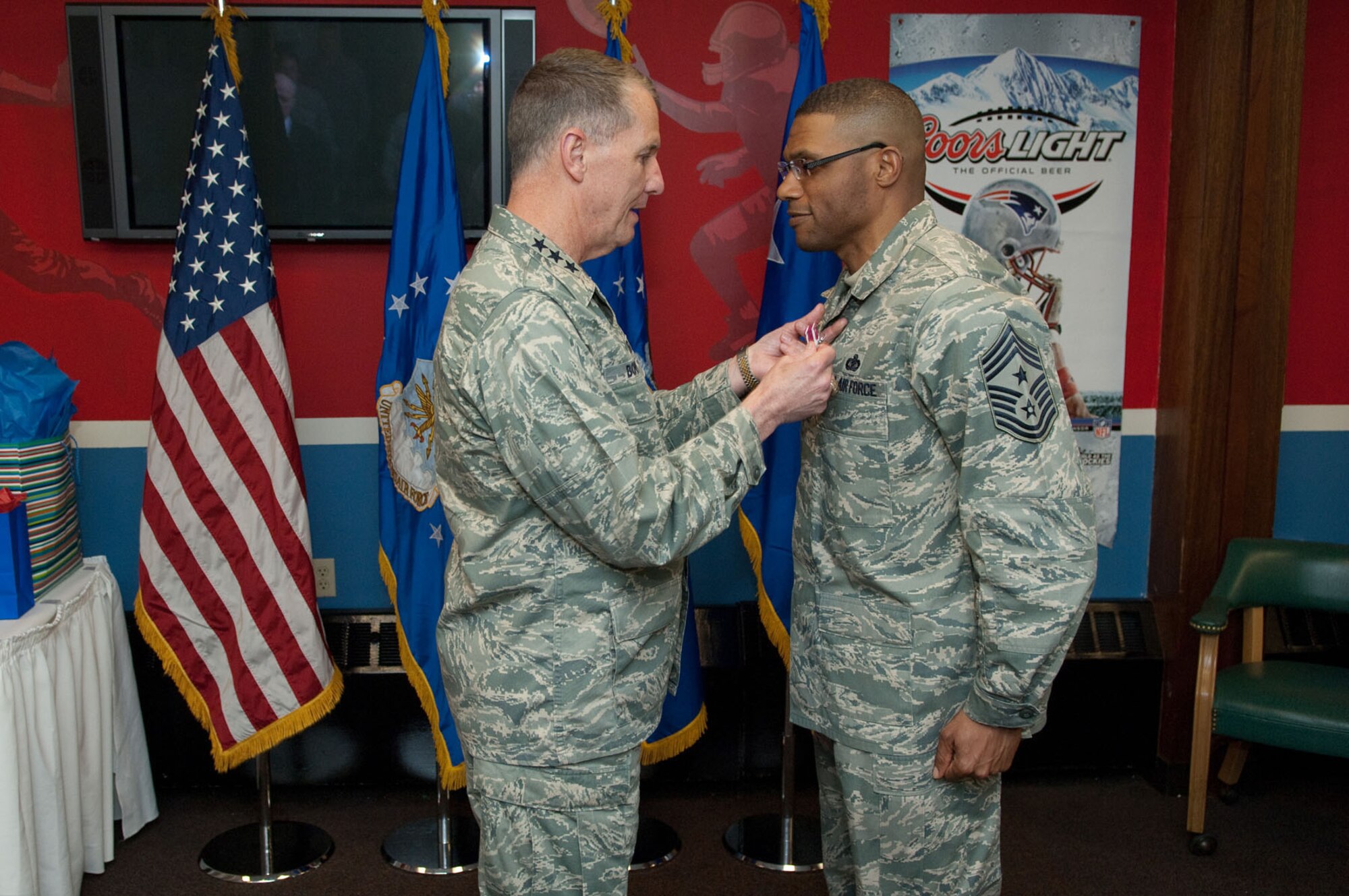 HANSCOM AIR FORCE BASE, Mass. – Lt. Gen. Ted Bowlds (left), Electronic Systems Center commander, presents the Meritorious Service Medal to Chief Master Sgt. Ken Williams, Electronic Systems Center command chief, during his farewell social at the Minuteman Club April 7. Chief Williams will soon begin a new assignment as Basic Military Training superintendent at Lackland AFB, Texas. (U.S. Air Force photo by Rick Berry)