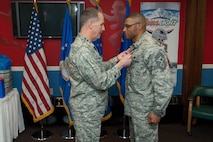 HANSCOM AIR FORCE BASE, Mass. – Lt. Gen. Ted Bowlds (left), Electronic Systems Center commander, presents the Meritorious Service Medal to Chief Master Sgt. Ken Williams, Electronic Systems Center command chief, during his farewell social at the Minuteman Club April 7. Chief Williams will soon begin a new assignment as Basic Military Training superintendent at Lackland AFB, Texas. (U.S. Air Force photo by Rick Berry)