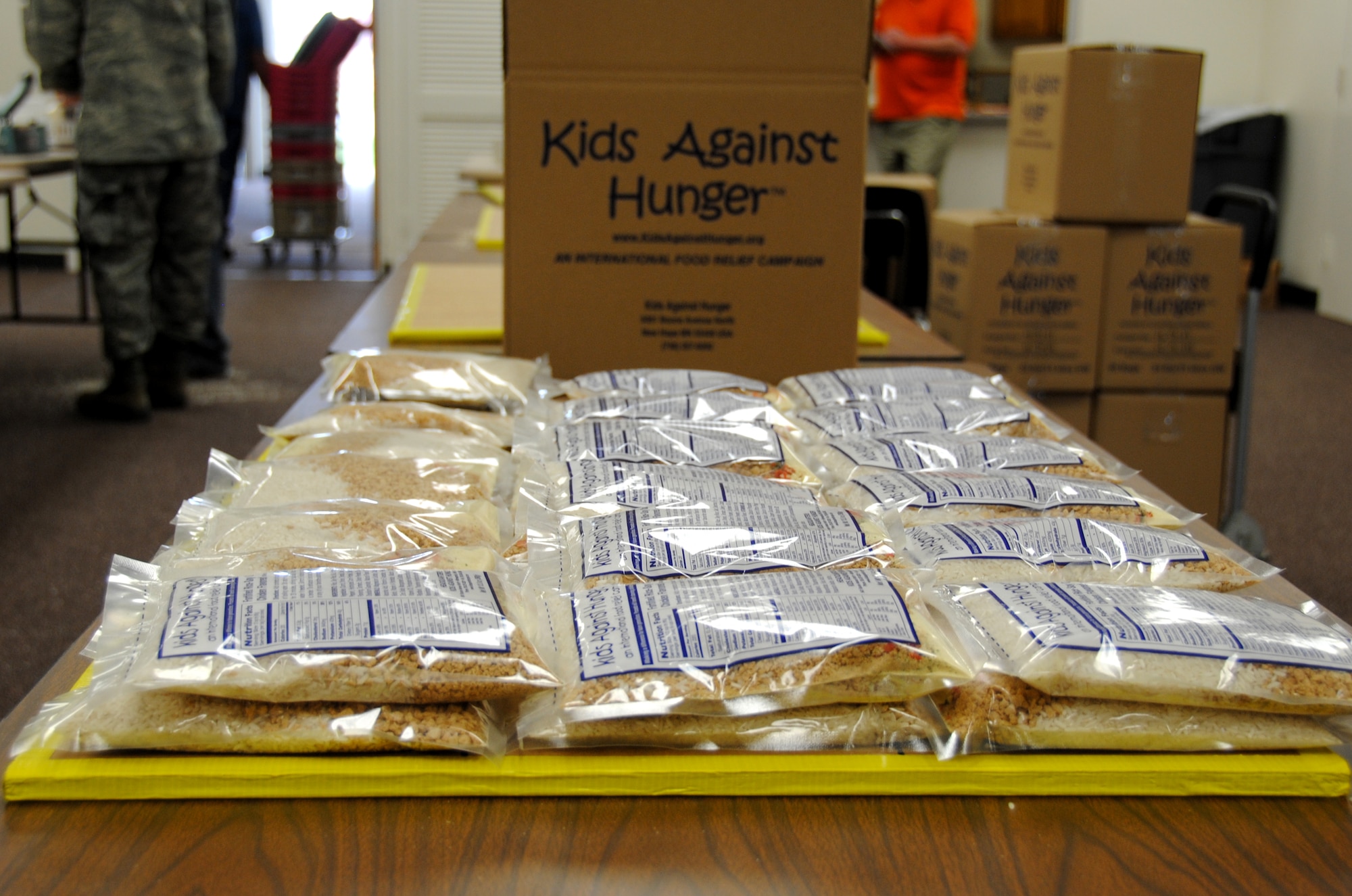 Almost 29,000 meal packages were prepared by 52 Vance volunteers April 7 in the Community Chapel Activity Center for Kids Against Hunger. Each package contains enough rice, soy, dehydrated vegetables, vitamins and minerals to feed six hungry people a nutritious meal. (U.S. Air Force photo/ 2nd Lt. Kiersten Thompson)