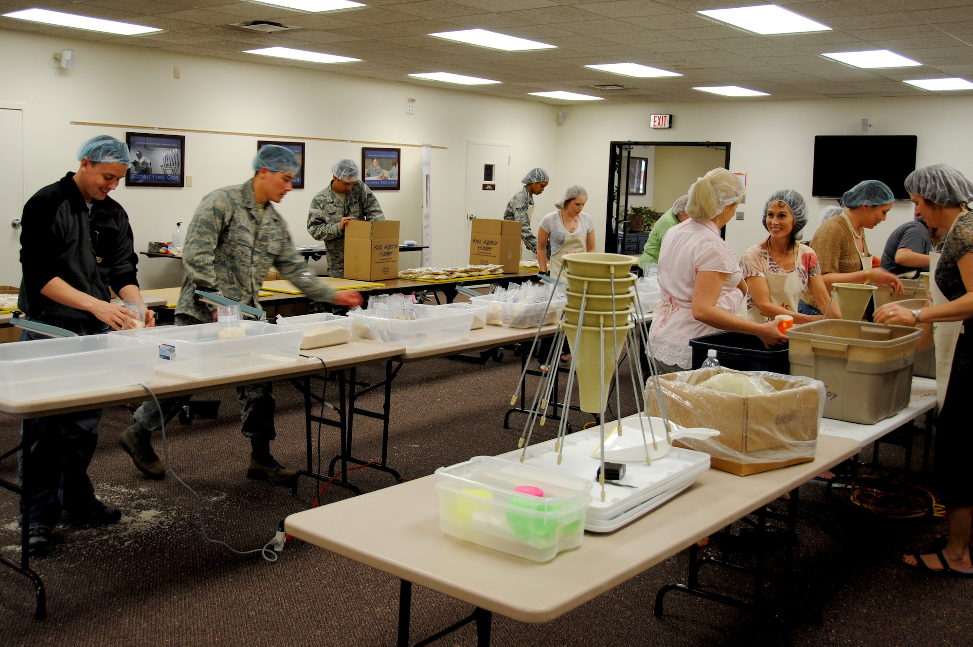 Fifty-two Team Vance volunteers assemble meal packages April 7 in the Community Chapel Activity Center for Kids Against Hunger, a nonprofit humanitarian food aid organization. By the end of the day, the volunteers had prepared almost 29,000 meal packages that can feed six. (U.S. Air Force photo/ 2nd Lt. Kiersten Thompson)