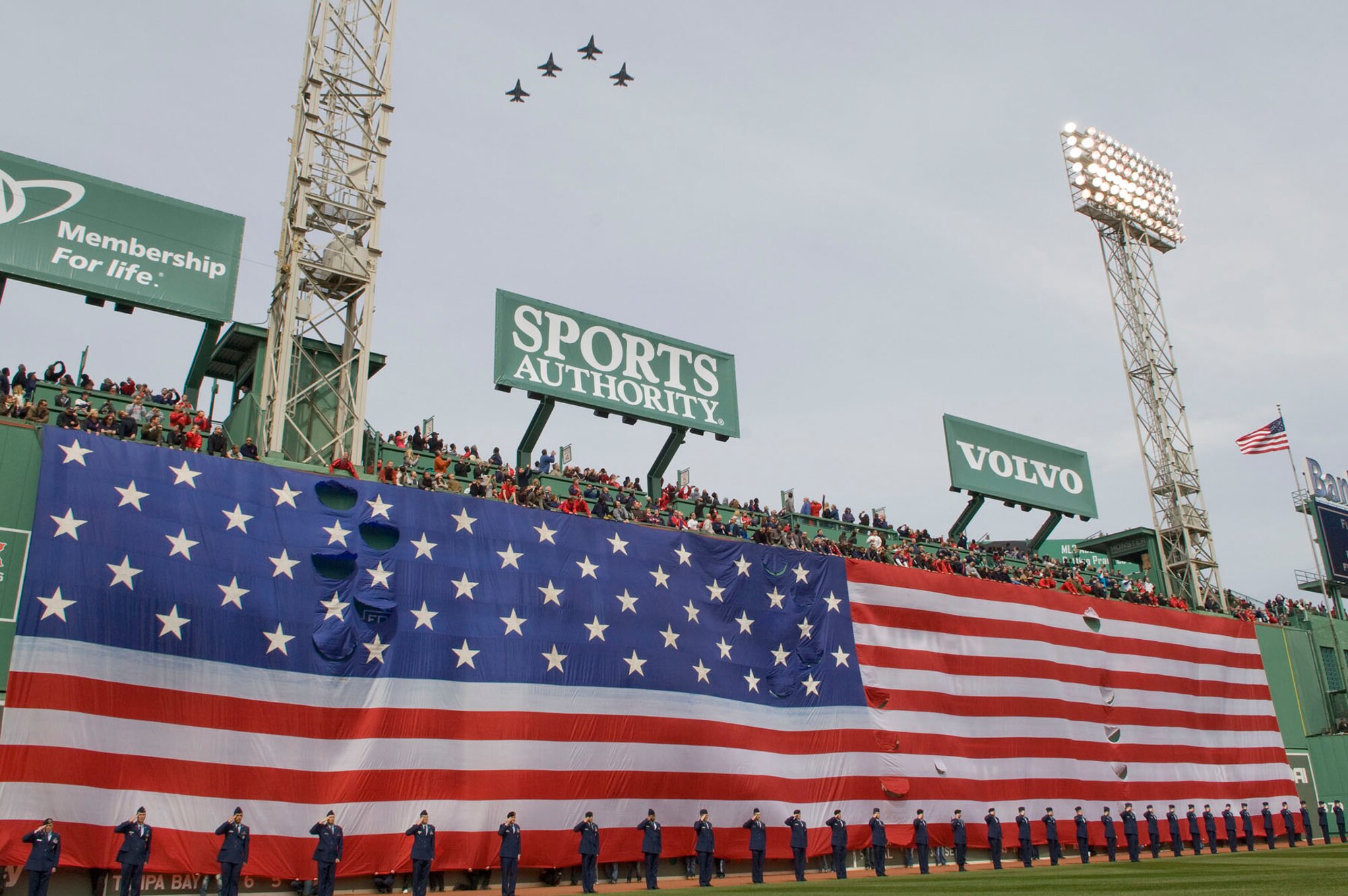 BOSTON – Airmen from Hanscom salute during the playing of the national anthem at Fenway Park for Boston Red Sox opening day festivities April 8. As the national anthem played, F-16s from the 158th Fighter Wing, part of the Vermont Air National Guard, soared overhead. (U.S. Air Force photo by Mark Wyatt)