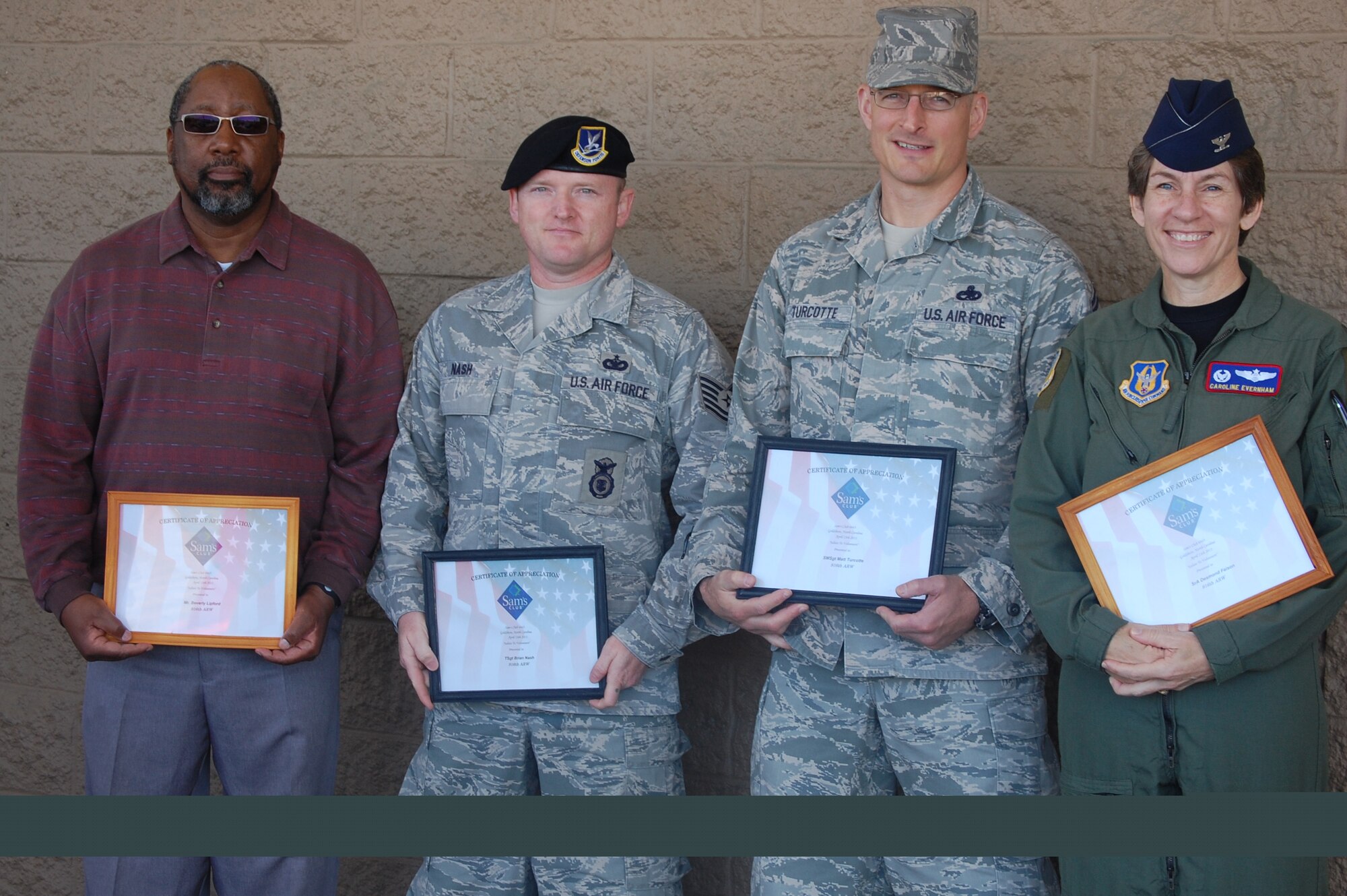 From left to right: Mr. Beverly Lipford, Tech. Sgt. Brian Nash, Senior Master Sgt. Matt Turcotte and Col. Caroline Evernham (representing SrA Desmond Faison) show their certificates presented for volunteer service. (Maj. Shannon Mann, 916ARW/PA)