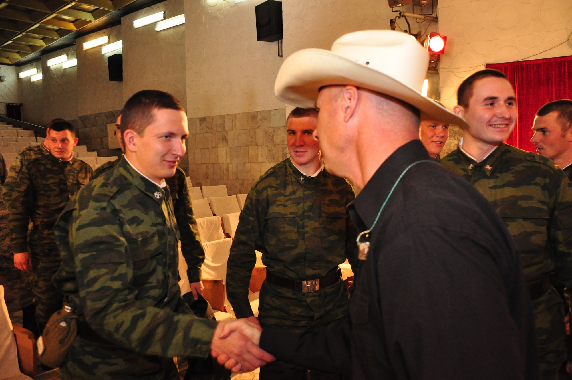 Technical Sgt. Stephen Brannen shakes hands with a member of the Russian military from Kant Air Base after AFCENT Band Wild Blue Country's performance at the Kant House of Culture. (U.S. Air Force photo by Daniel Nathaniel III)