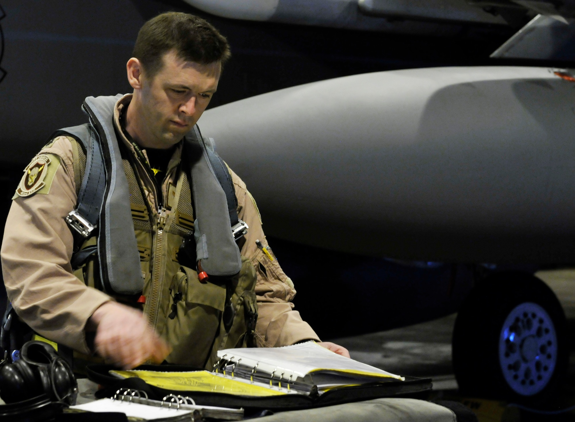 ROYAL AIR FORCE LAKENHEATH, England - Lt. Col. Skip Pribyl, 493rd Fighter Squadron commander, checks aircraft records prior to boarding an F-15 Eagle at RAF Lakenheath on April 8, 2011. The 493rd FS deployed Airmen and assets to an undisclosed location in Southwest Asia. (U.S. Air Force photo/Senior Airman Tiffany M. Deuel)