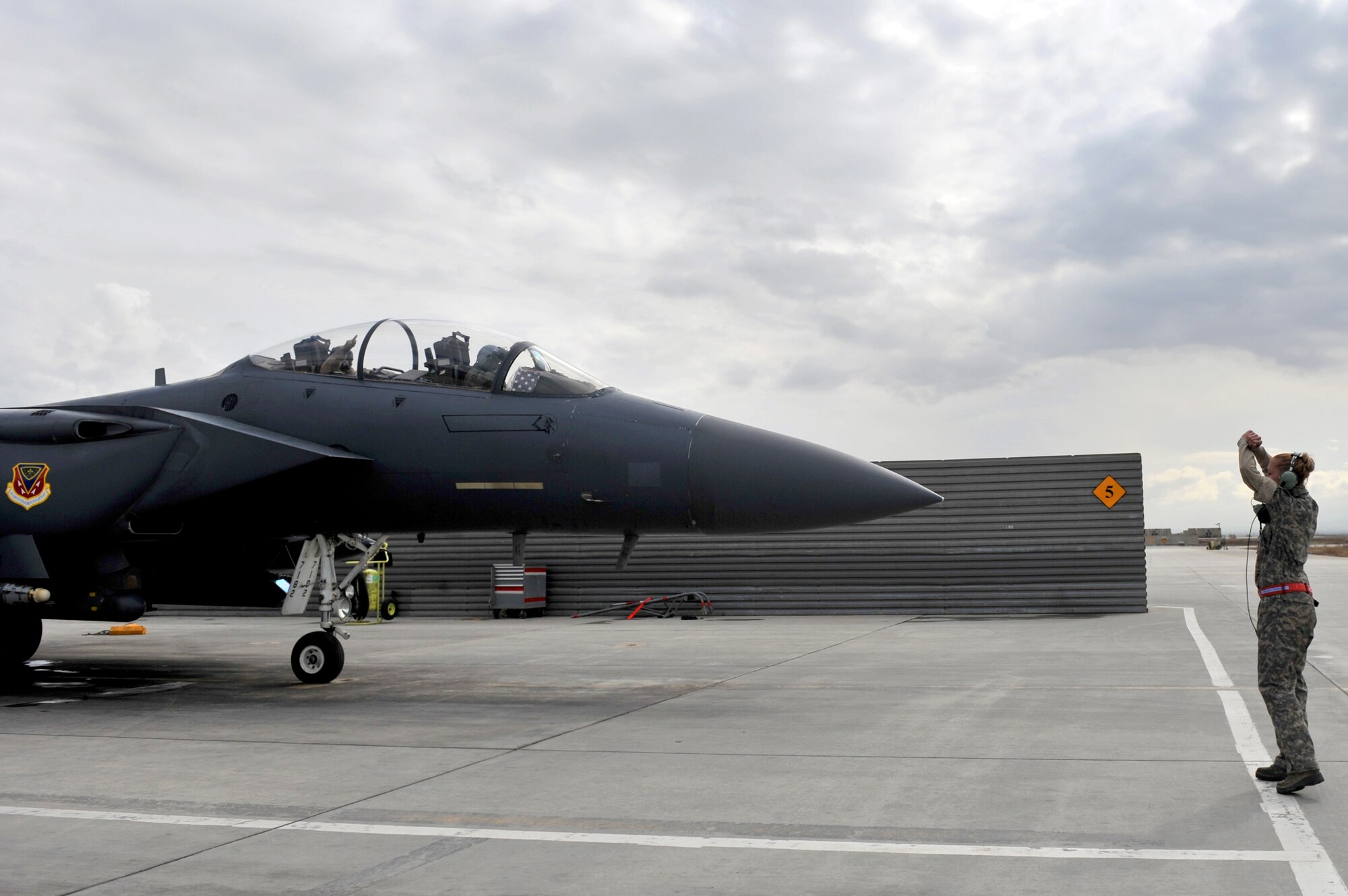 Staff Sgt. Tamara Rhone, 455th Expeditionary Aircraft Maintenance Squadron crew chief, directs the aircrew as they prepares to head down the runaway at Bagram Airfield, Afghanistan, March 29, 2011. (U.S. Air Force photo by Senior Airman Sheila deVera)
