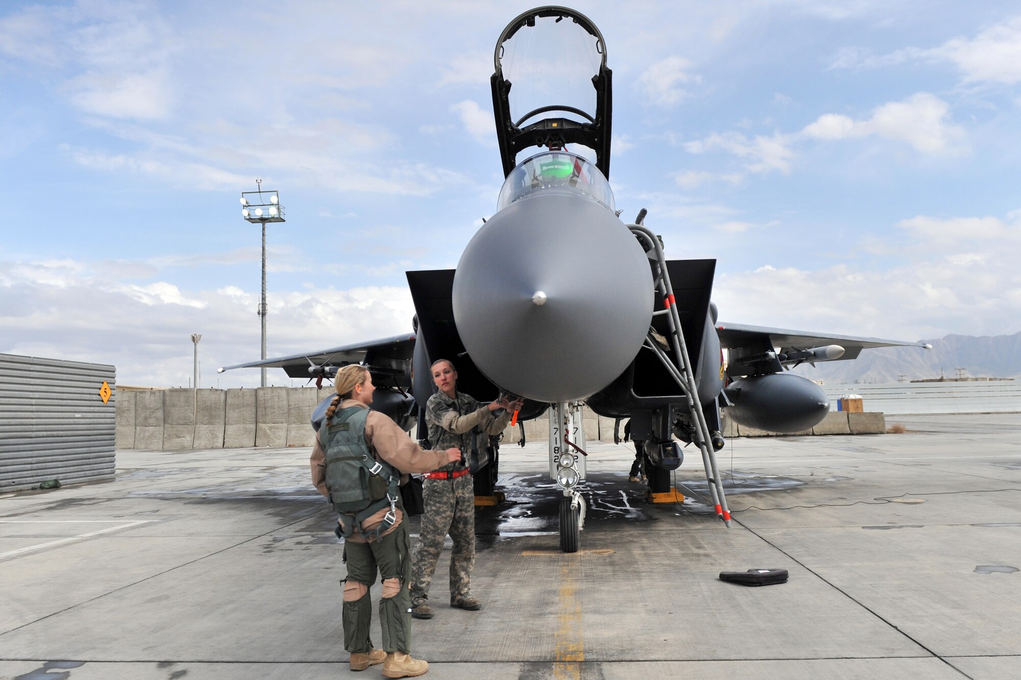 Staff Sgt. Tamara Rhone, 455th Expeditionary Aircraft Maintenance Squadron crew chief, prepares to open a panel for Capt. Jennifer Morton, 389th Expeditionary Fighter Squadron weapons system officer, to inspect prior to take-off at Bagram Airfield, Afghanistan, March 29, 2011. (U.S. Air Force
photo by Senior Airman Sheila deVera)
