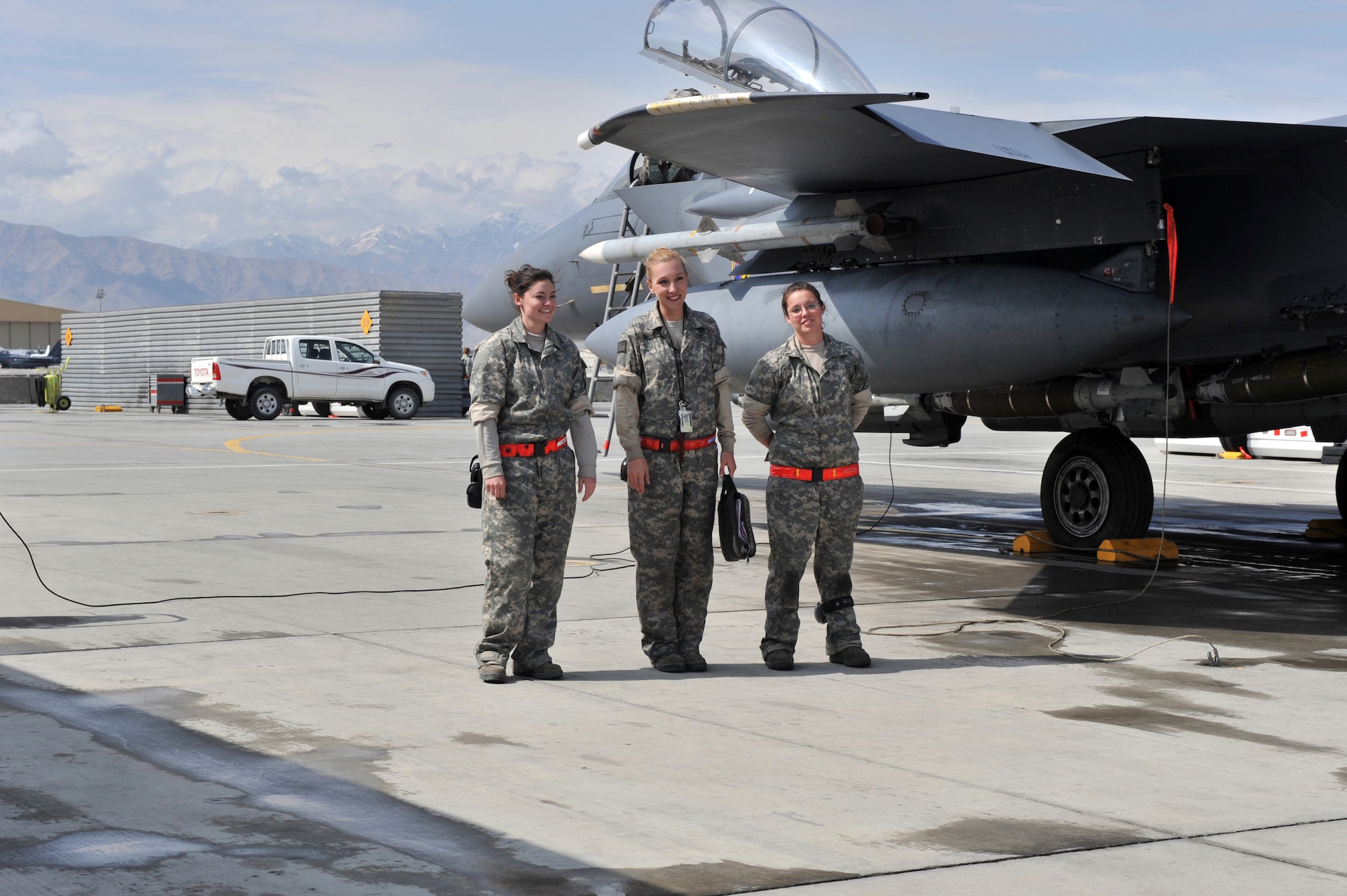 (Left to Right) Airman 1st Class Reata Cantwell, Staff Sgt. Tamara Rhone,
and A1C Alexandria Roope, all from the 455th Expeditionary Aircraft
Maintenance Squadron, wait for the Dudette 07 aircrew at Bagram Airfield,
Afghanistan, March 29, 2011. A1C Cantwell and Roope were the weapons load
crew, and Sergeant Rhone was the aircraft crew chief. (U.S. Air Force photo
by Senior Airman Sheila deVera)
