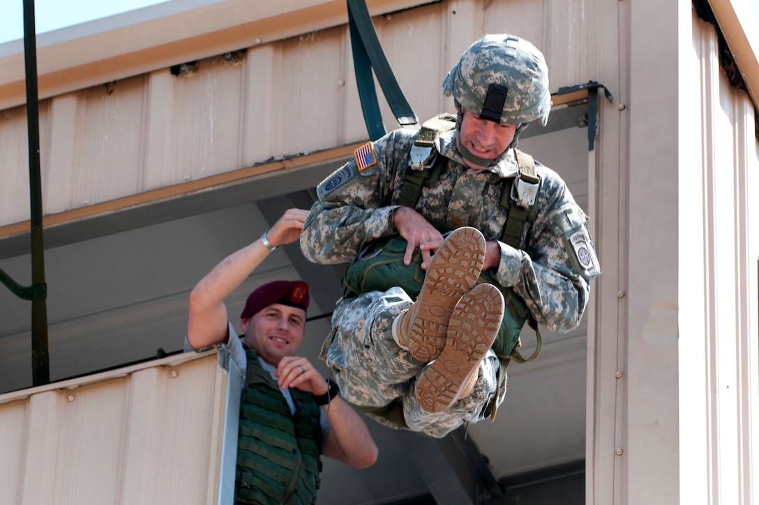 U.S. Army Maj. Sean Barrett jumps from a 40-foot parachute training tower at the Advanced Airborne School during Prop Blast, a traditional event that welcomes new officers to the division on Fort Bragg, N.C., April 8, 2011. Barrett is assigned to the 82nd Airborne Division’s 1st Brigade Combat Team.