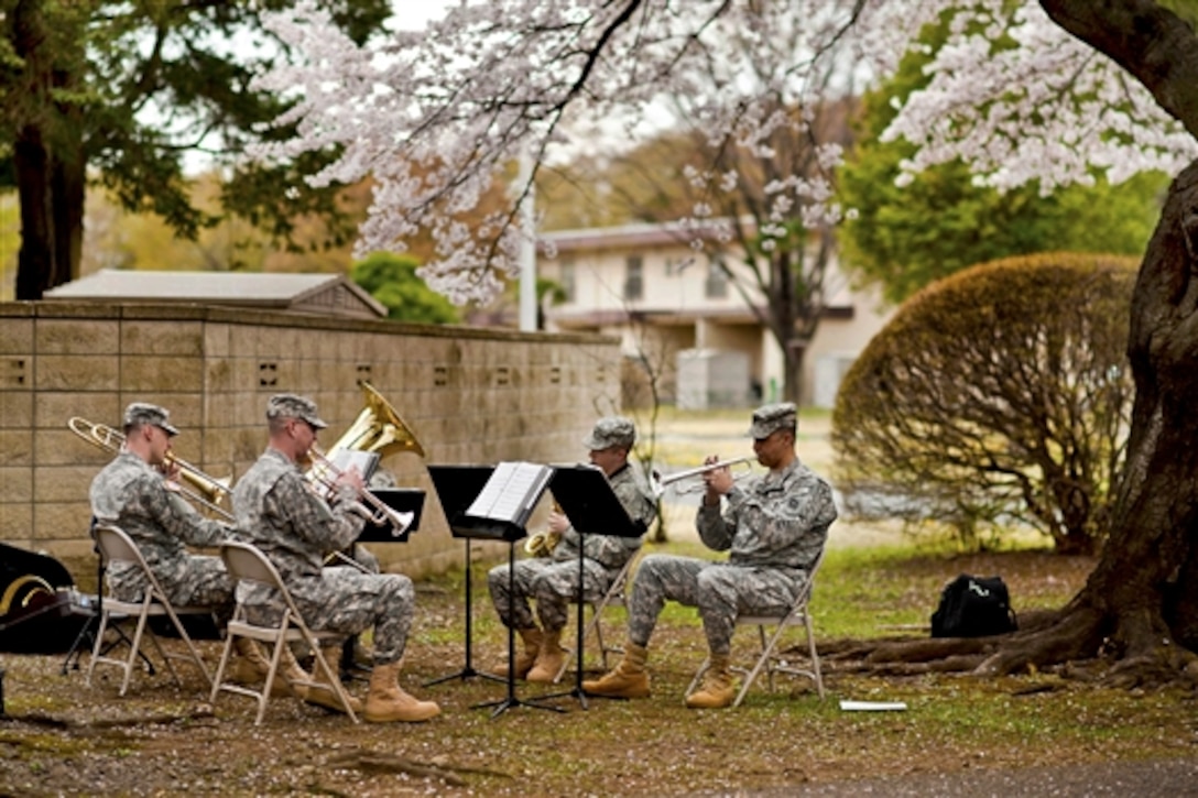 U.S. Air Force airmen perform for Japanese visitors viewing cherry blossoms on Yokota Air Base, Japan, April 10, 2011. Yokota officials opened the base to Japanese neighbors to view the canopy of cherry blossoms along the road.