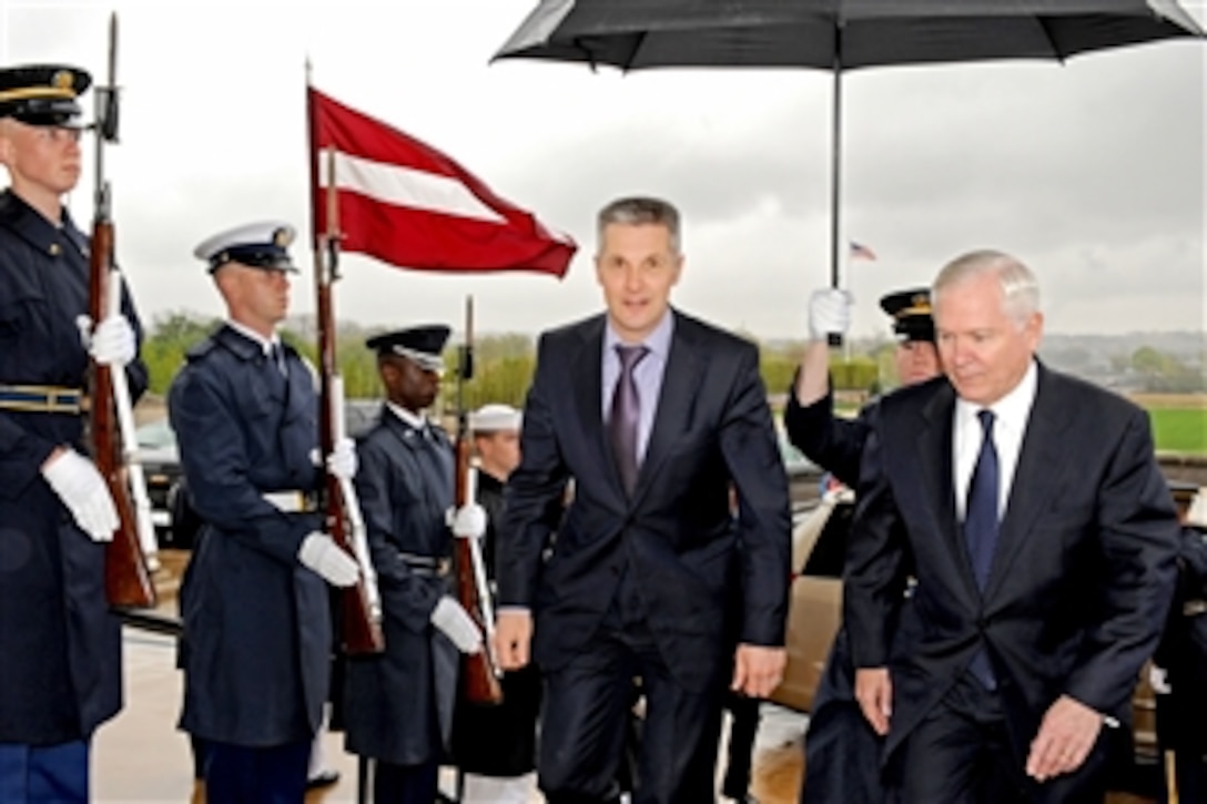 Secretary of Defense Robert M. Gates escorts Latvian Minister of Defense Artis Pabriks (left) through an honor cordon and into the Pentagon for bilateral security discussions on April 13, 2011.  