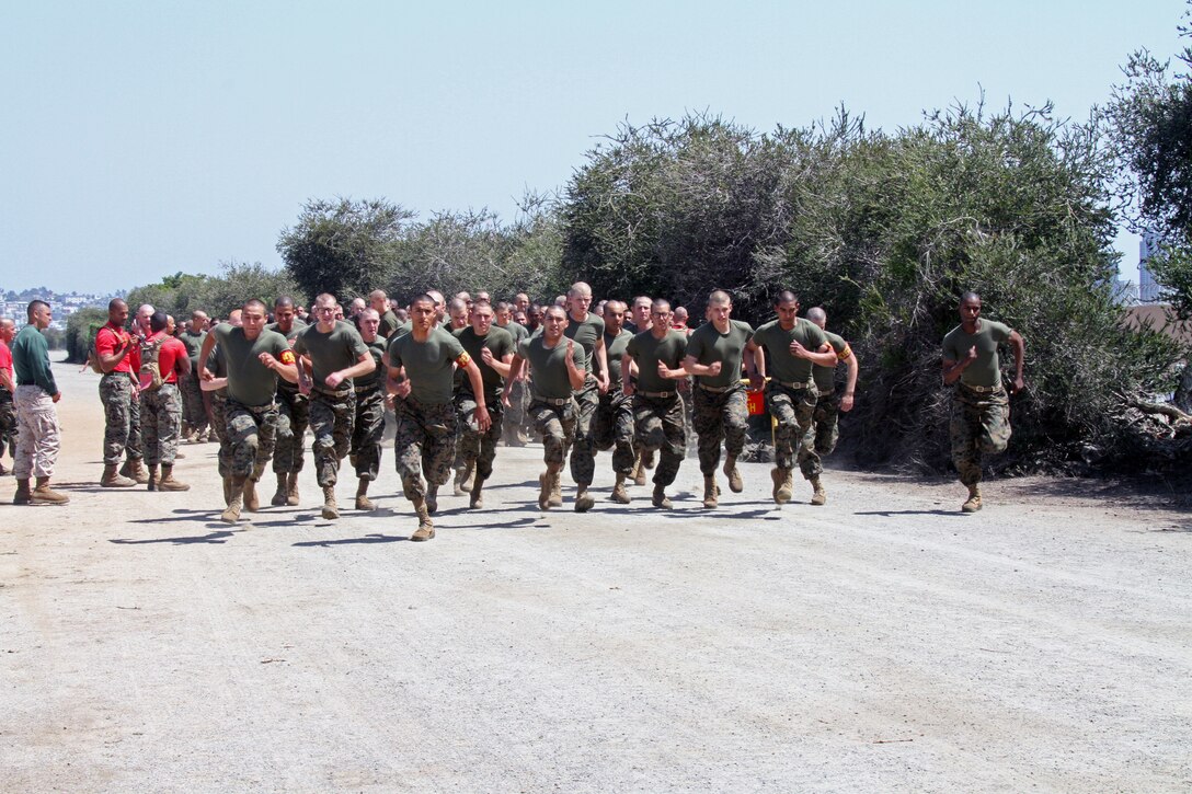 Company C, 1st Recruit Training Battalion recruits sprint during the movement to contact portion of the Combat Fitness Test April 14. The movement to contact is the first event in the CFT. It is followed by the ammunition can lifts and the maneuver under fire course.