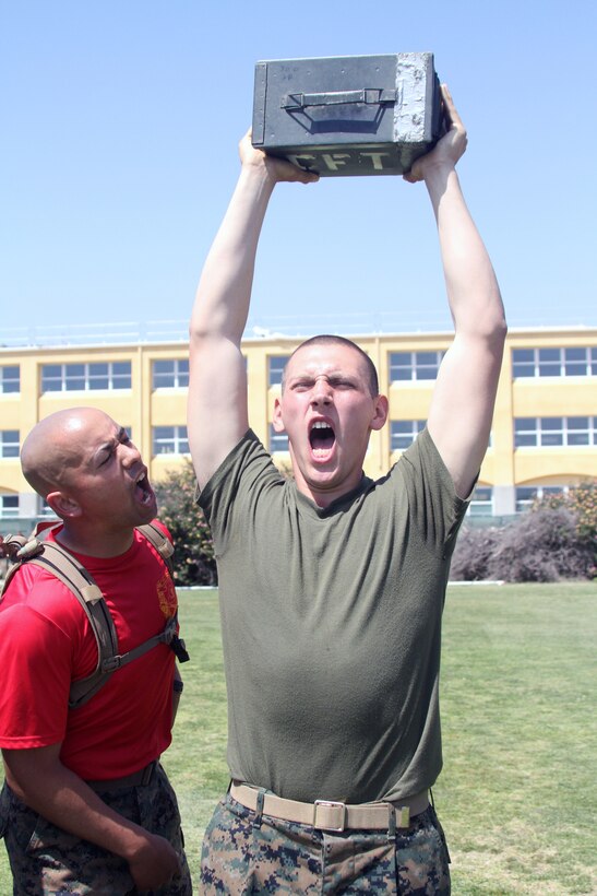 A Company C, 1st Recruit Training Battalion recruit does ammunition can lifts while his drill instructor motivates him during a Combat Fitness Test April 14. The CFT is an annual training requirement for all Marines to ensure they’re able to endure the rigors of combat.