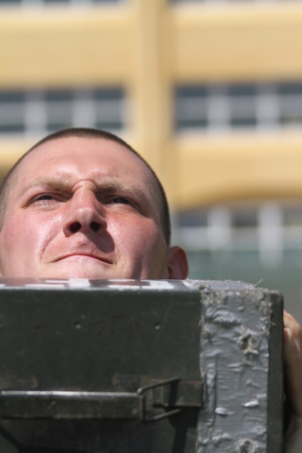 A recruit with Company C, 1st Recruit Training Battalion, prepares to thrust the ammunition can into the air during the Combat Fitness Test April 14. The CFT is an annual training requirement for all Marines to ensure they’re able to endure the rigors of combat.
